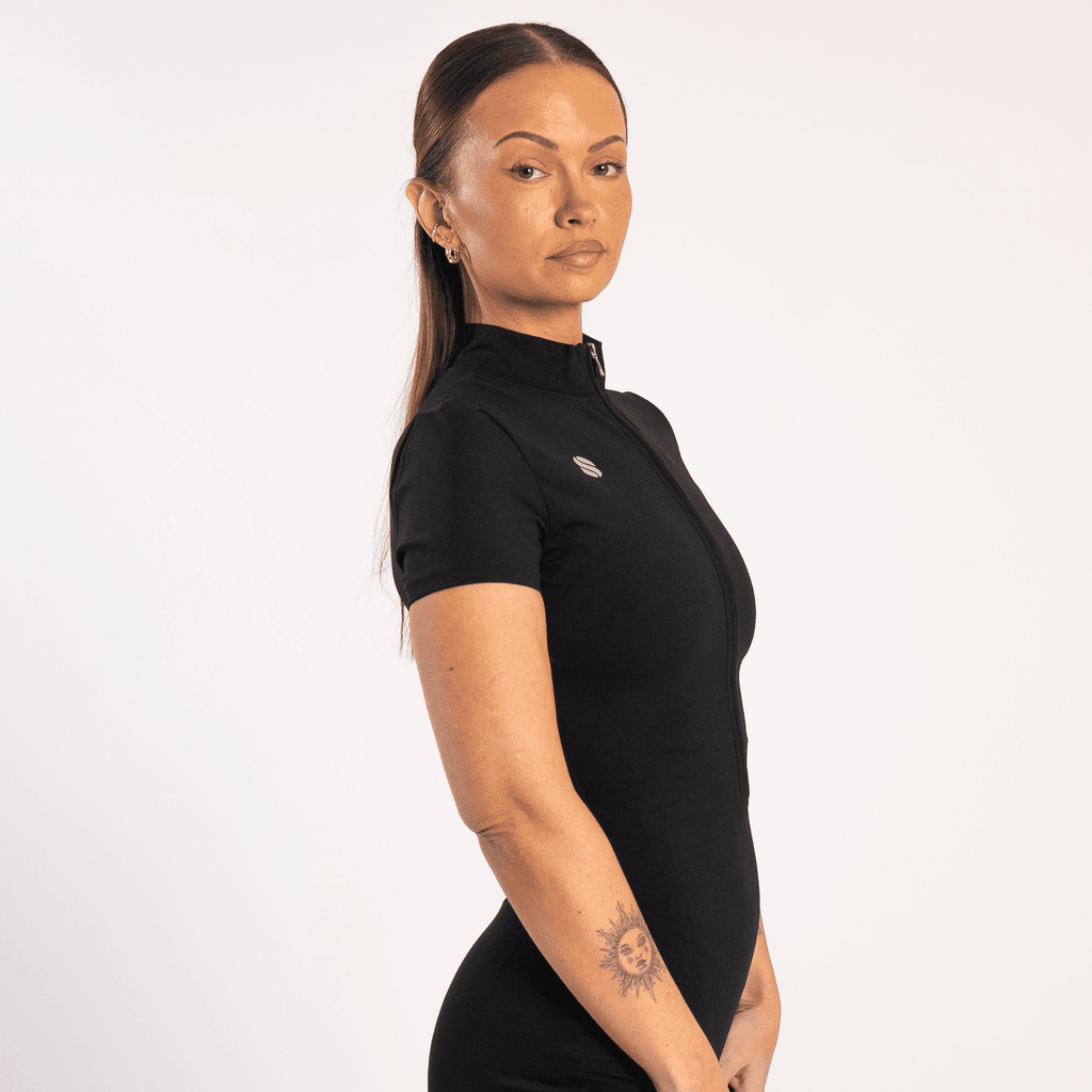Woman wearing the All in one Jumpsuit Black by sporton.active against a white background.