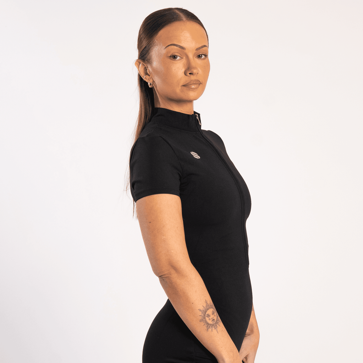 Woman wearing the All in one Jumpsuit Black by sporton.active against a white background.