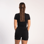 Back view of a woman wearing the All in one Jumpsuit Black by sporton.active
