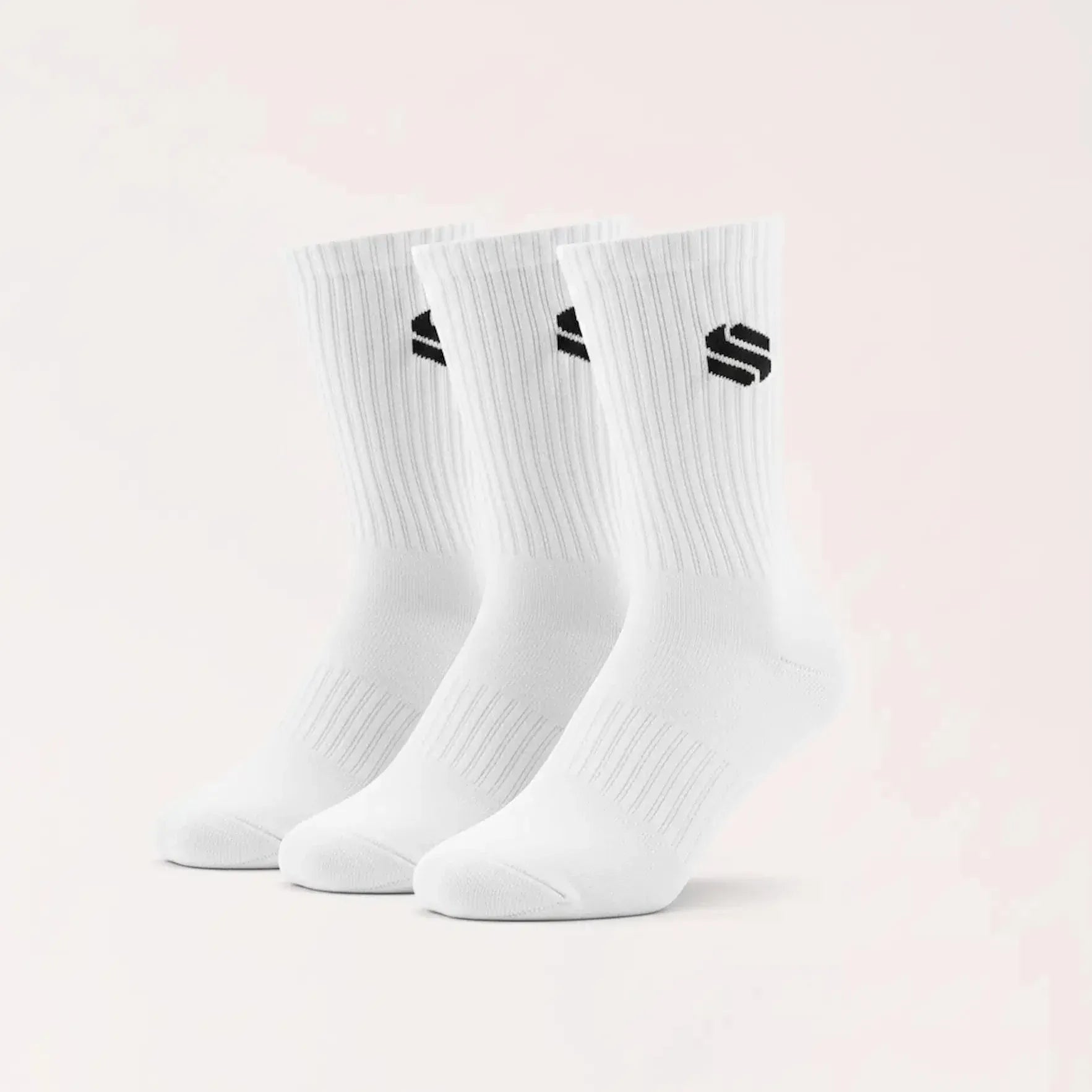 A set of three white crew-length athletic socks displayed standing upright, each featuring a small black geometric logo on the ribbed upper cuff.