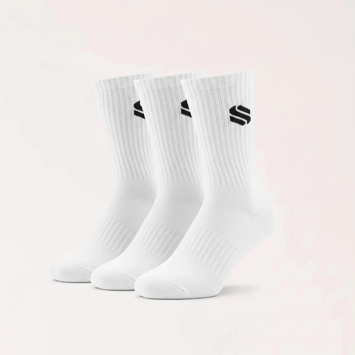 A set of three white crew-length athletic socks displayed standing upright, each featuring a small black geometric logo on the ribbed upper cuff.
