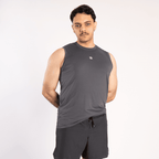 A man wearing a charcoal grey sleeveless crew neck tank top with a small white logo on the chest and matching black athletic shorts against a plain white background.